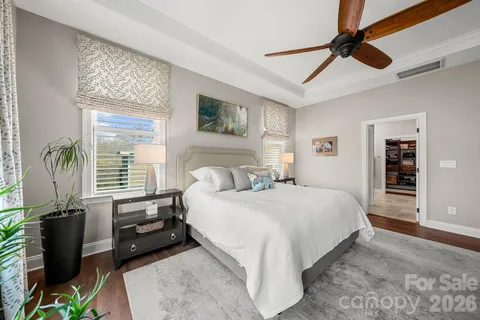 a bedroom with a bed and a television