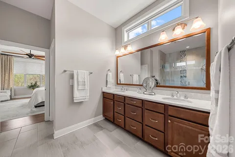 a bathroom with a granite countertop sink mirror and toilet