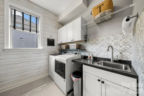 a kitchen that has a sink and a stove