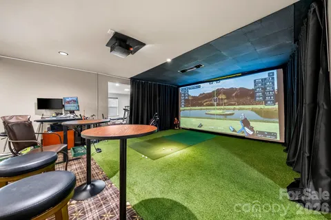 a living room with furniture pool table and a flat screen tv