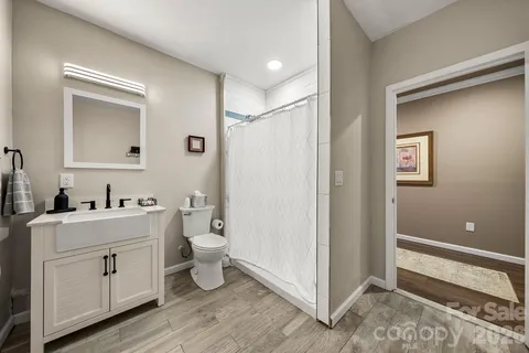 a bathroom with a toilet sink and mirror