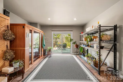 a view of hallway with furniture and floor to ceiling window
