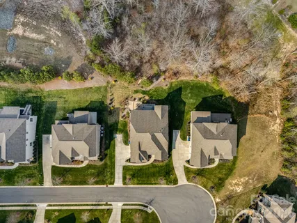 an aerial view of a house with a yard and lake view