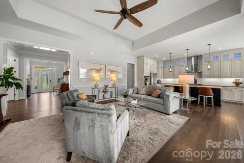 a living room with lots of furniture and kitchen view