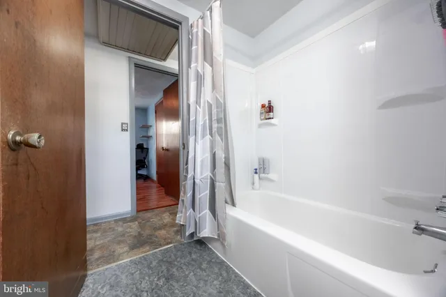 a bathroom with a bathtub and a shower