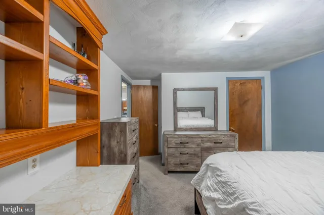 a bedroom with a bed and a dresser