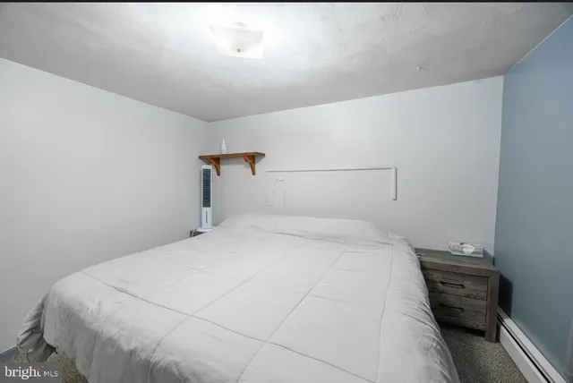 a bedroom with a bed and a table