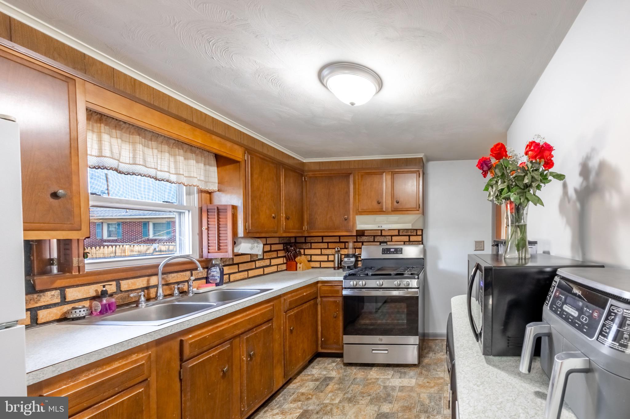 110 South Blettner Avenue Hanover, PA 17331 - Photo 6 of 30 a kitchen with granite countertop a sink stainless steel appliances and cabinets