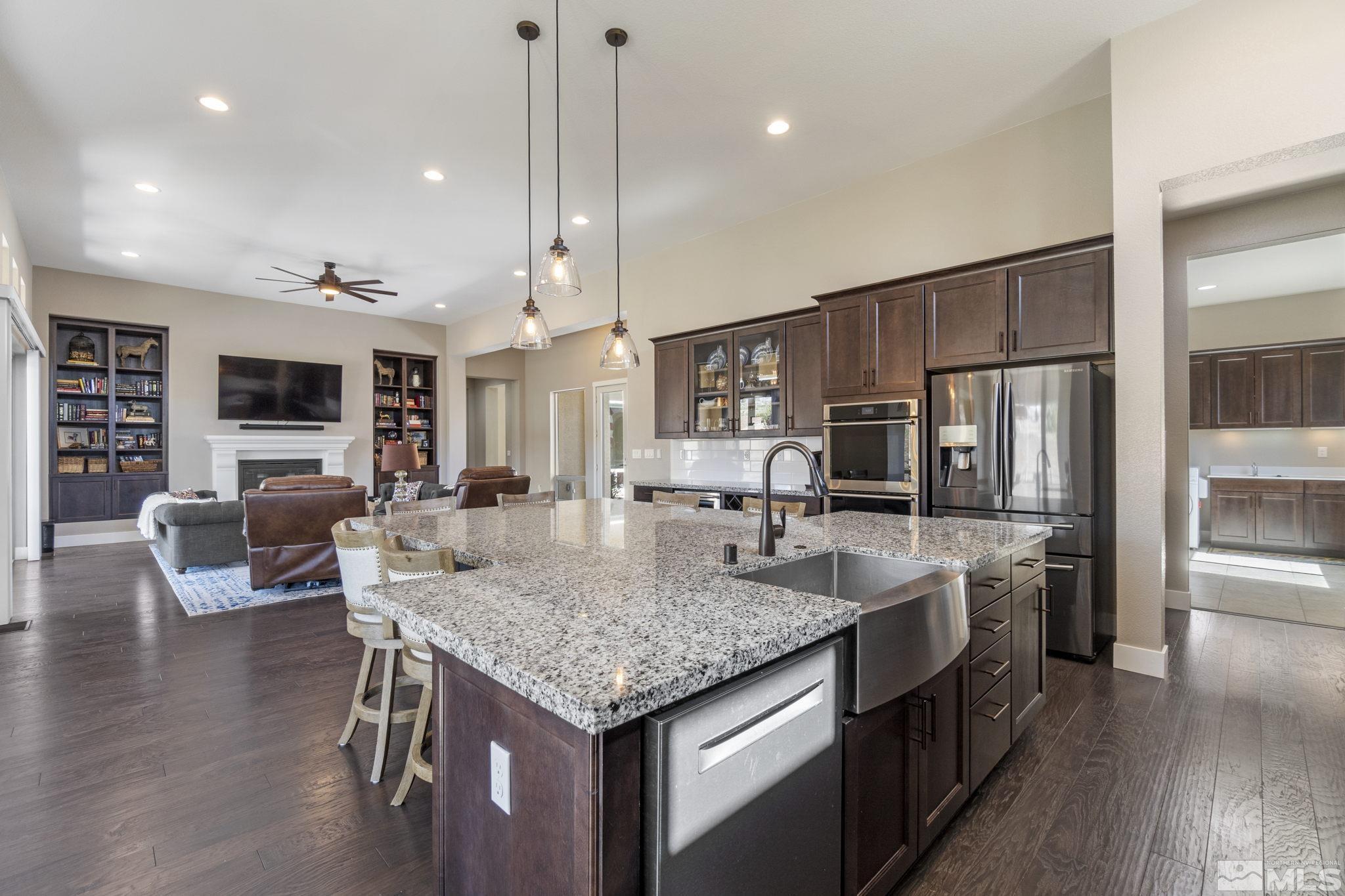 13357 Travertine Lane Reno, NV 89511 - Photo 17 of 39 a kitchen with stainless steel appliances granite countertop a kitchen island a stove and a sink