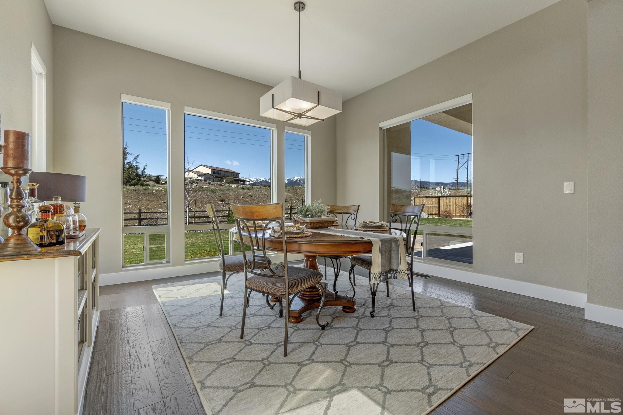 13357 Travertine Lane Reno, NV 89511 - Photo 20 of 39 a dining room filled with lots of furniture a chandelier and a rug