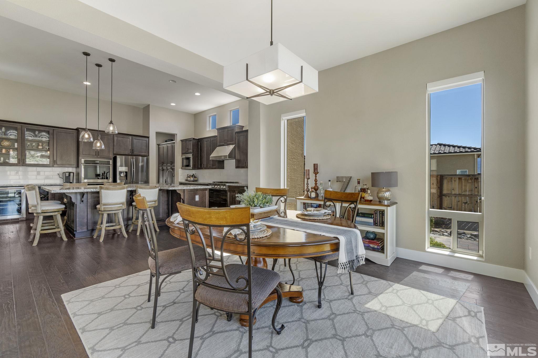 13357 Travertine Lane Reno, NV 89511 - Photo 21 of 39 a view of a dining room with furniture and wooden floor