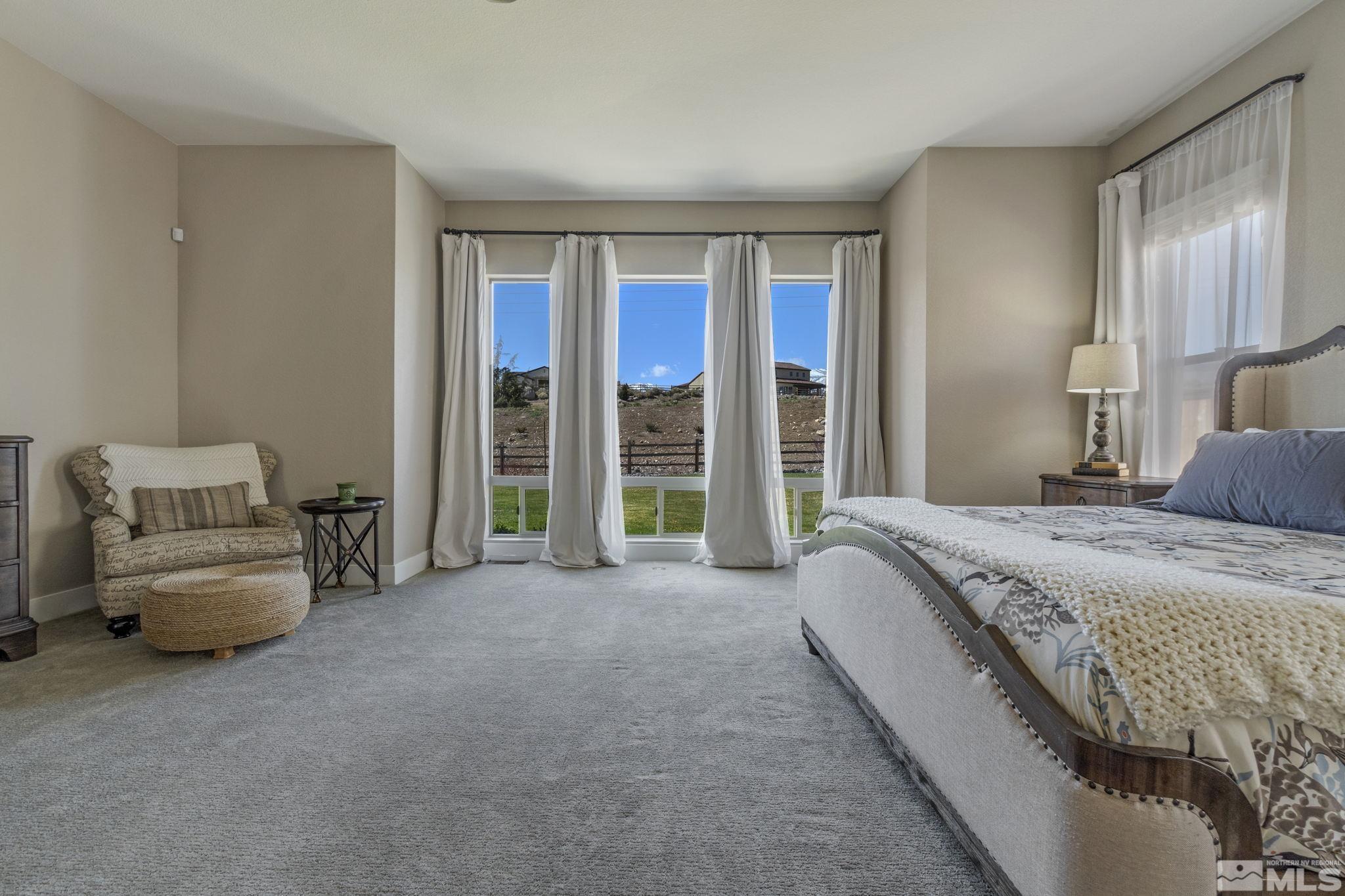 13357 Travertine Lane Reno, NV 89511 - Photo 24 of 39 a spacious bedroom with a bed and a couch