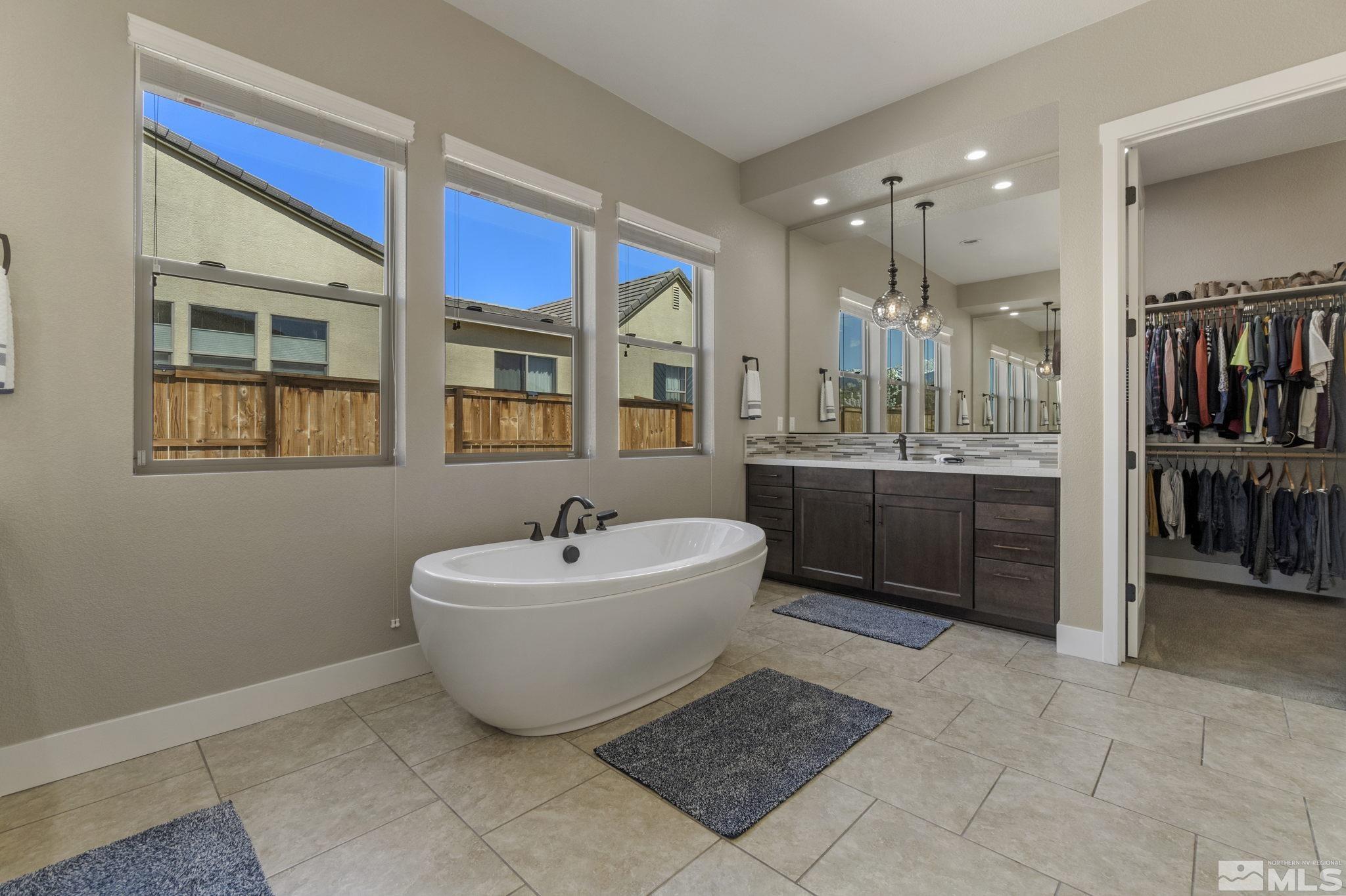 13357 Travertine Lane Reno, NV 89511 - Photo 26 of 39 a spacious bathroom with a tub sink and mirror