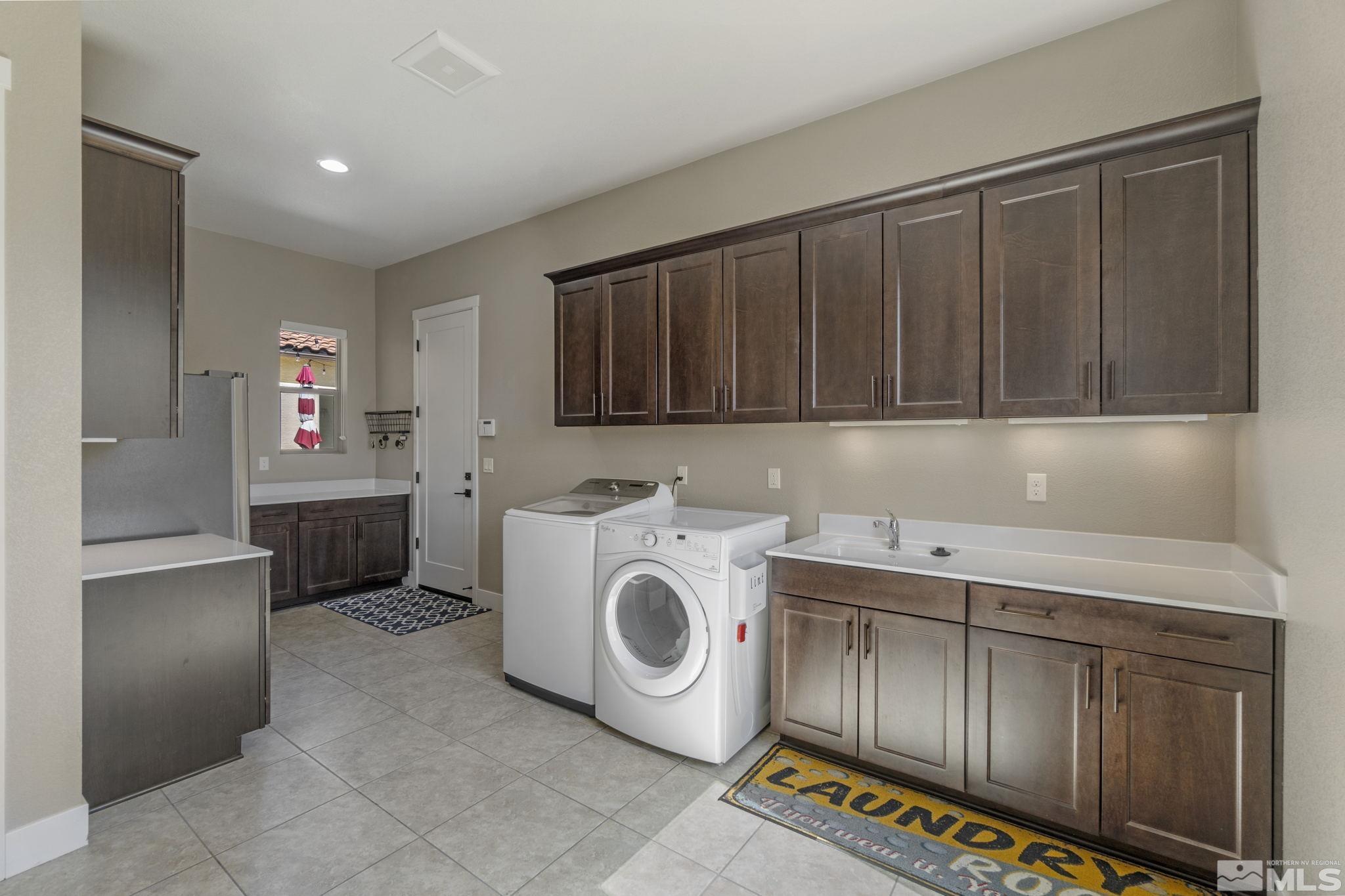 13357 Travertine Lane Reno, NV 89511 - Photo 34 of 39 a utility room with sink dryer and washer
