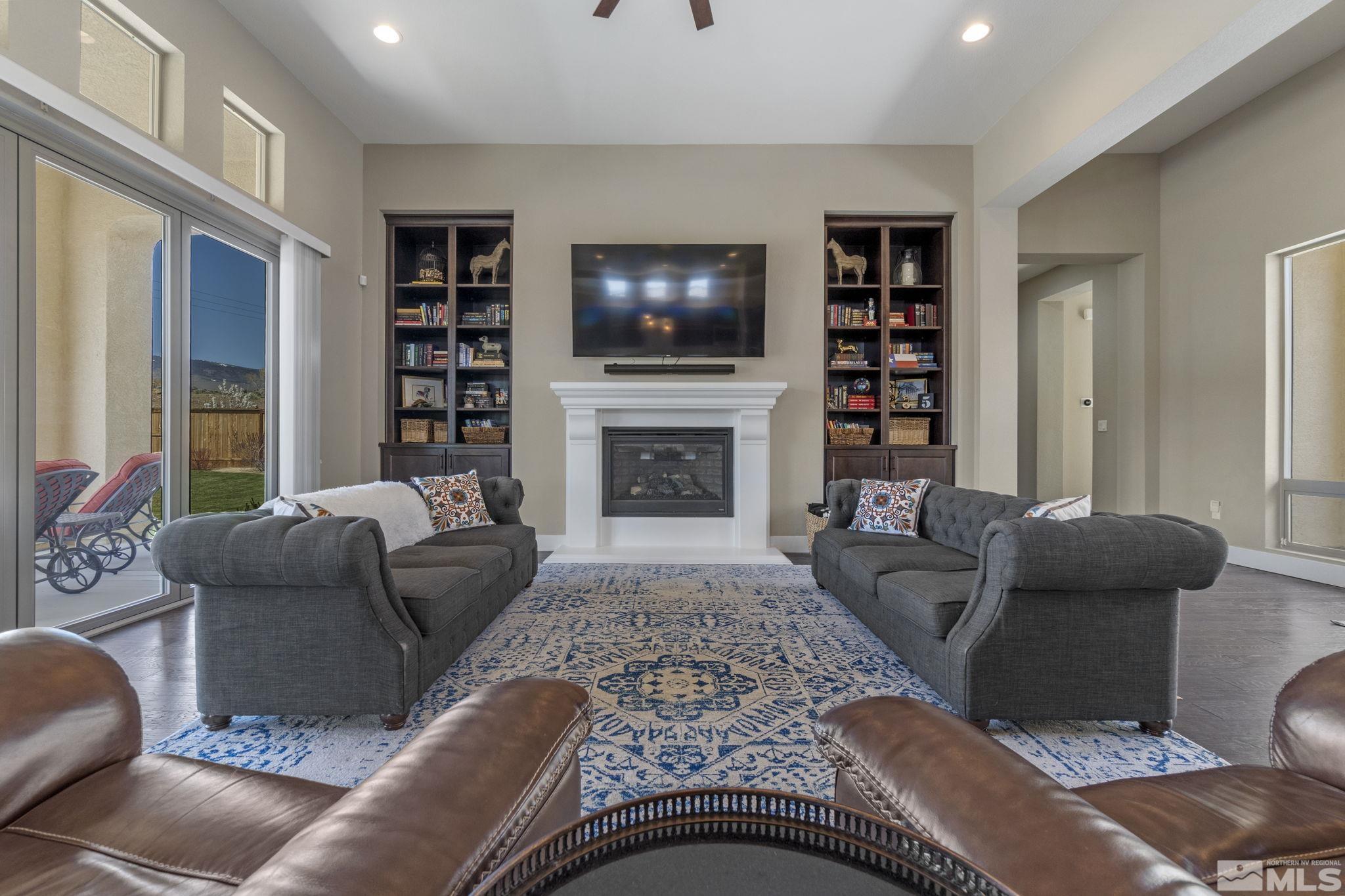 13357 Travertine Lane Reno, NV 89511 - Photo 8 of 39 a living room with furniture flat screen tv and a fireplace