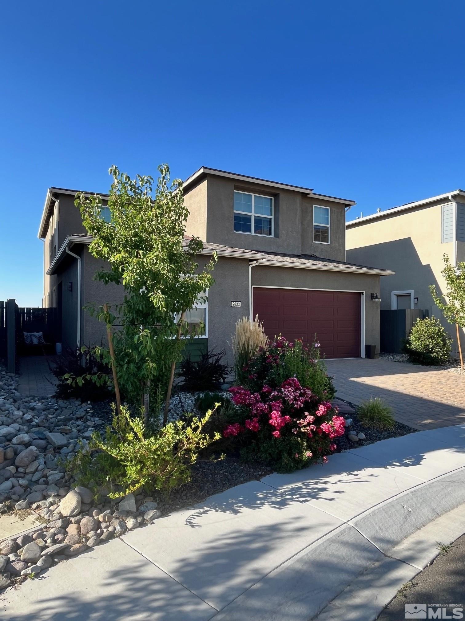 2833 Thistle Pine Court Reno, NV 89521 - Photo 1 of 25 a front view of a house with a yard