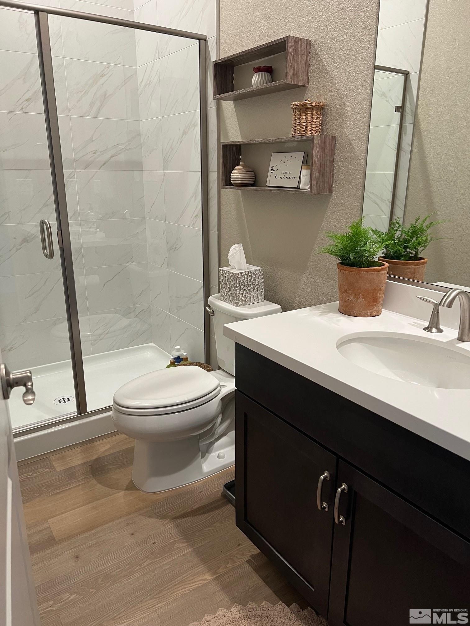 2833 Thistle Pine Court Reno, NV 89521 - Photo 15 of 25 a bathroom with a sink a toilet and shower
