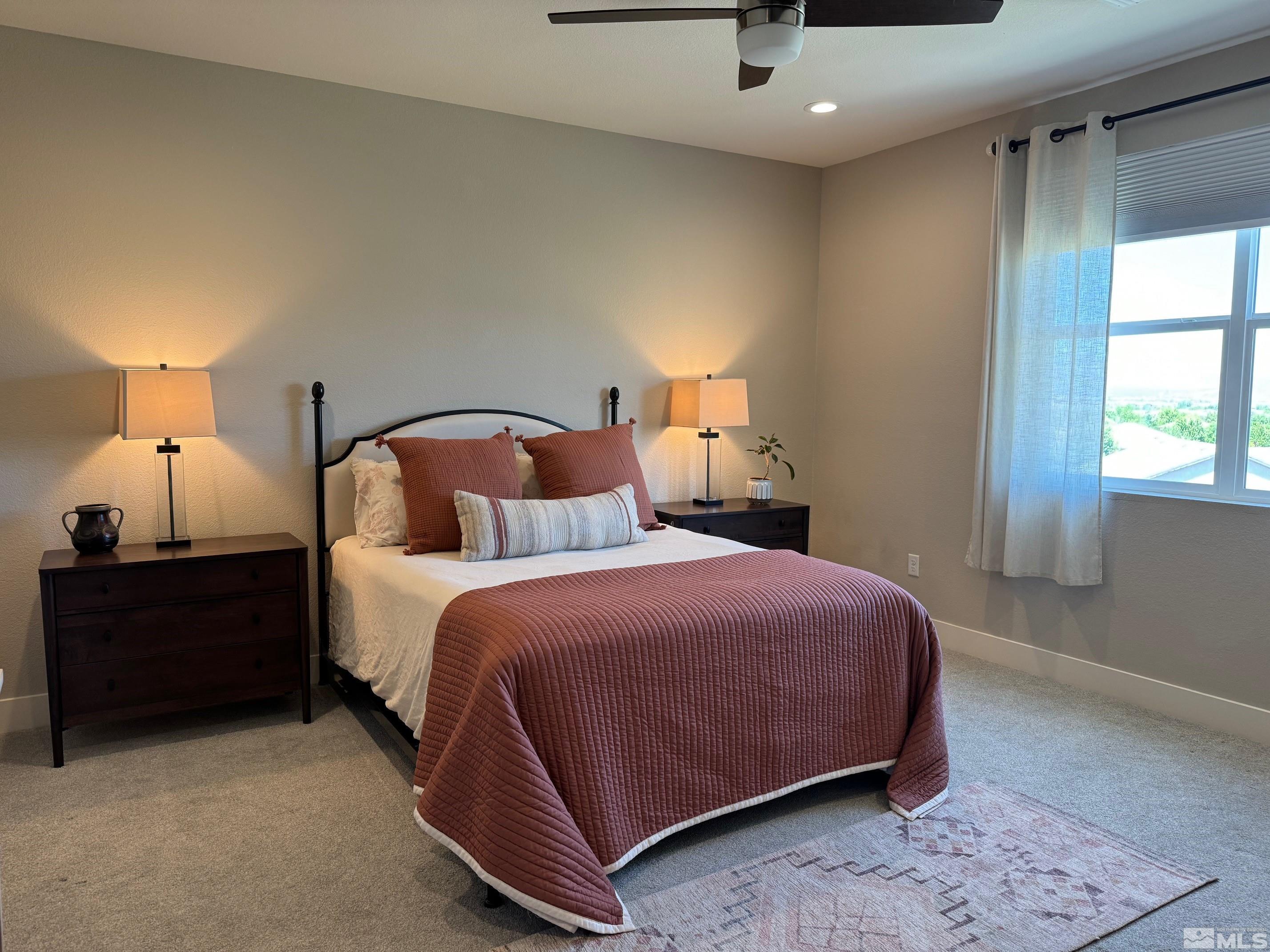 2833 Thistle Pine Court Reno, NV 89521 - Photo 8 of 25 a bedroom with a bed and a night stand