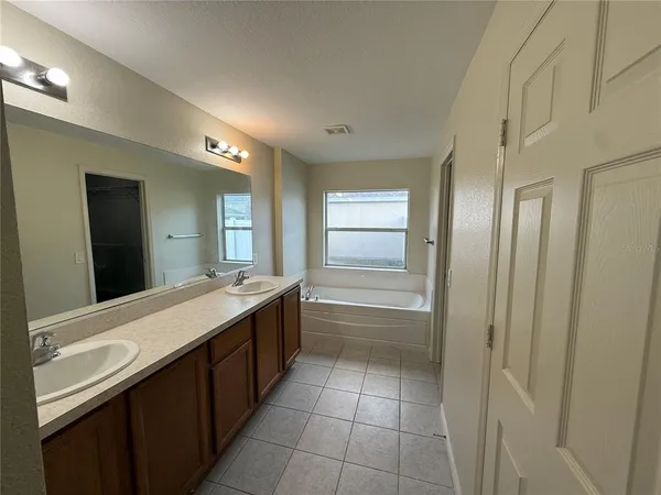 a bathroom with a granite countertop sink a toilet and mirror