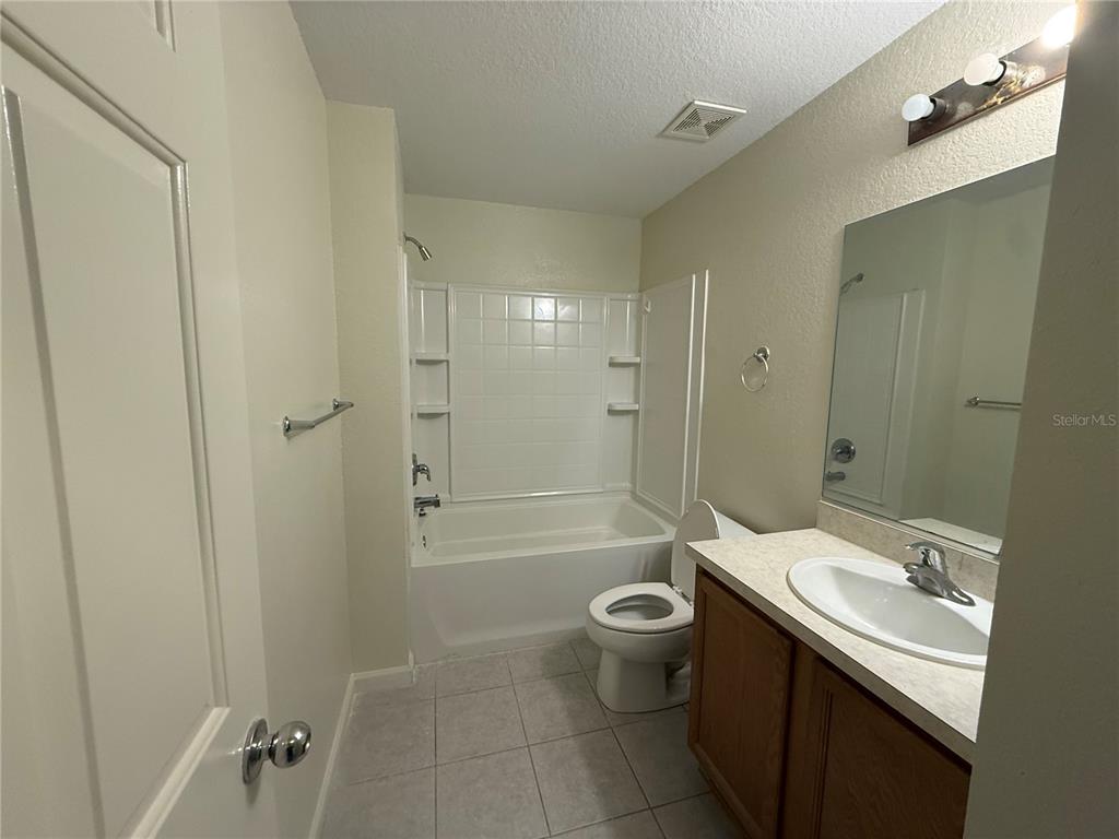 5000 Southwest 40th Place Ocala, FL 34474 - Photo 15 of 19 a bathroom with a sink a toilet and shower