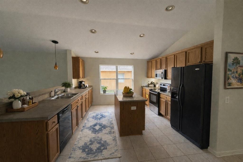 5000 Southwest 40th Place Ocala, FL 34474 - Photo 9 of 19 a kitchen with granite countertop a refrigerator stove and sink