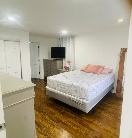 a bedroom with a bed and a television in it