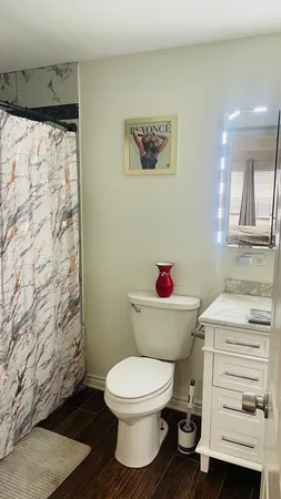 a bathroom with a toilet and a shower curtain
