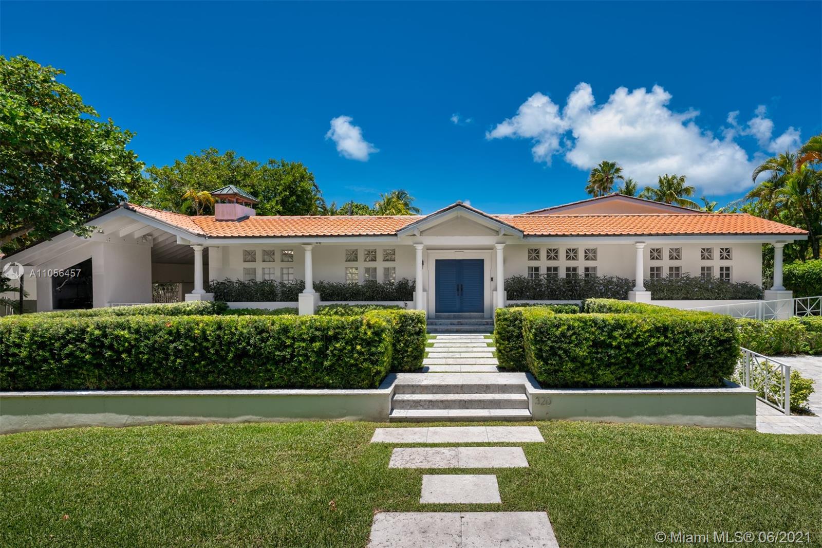 320 Pacific Road Key Biscayne, FL 33149 - Photo 2 of 27 a front view of house with yard and green space