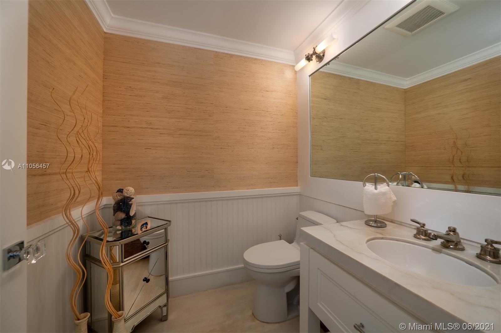 320 Pacific Road Key Biscayne, FL 33149 - Photo 13 of 27 a bathroom with a toilet a sink and mirror