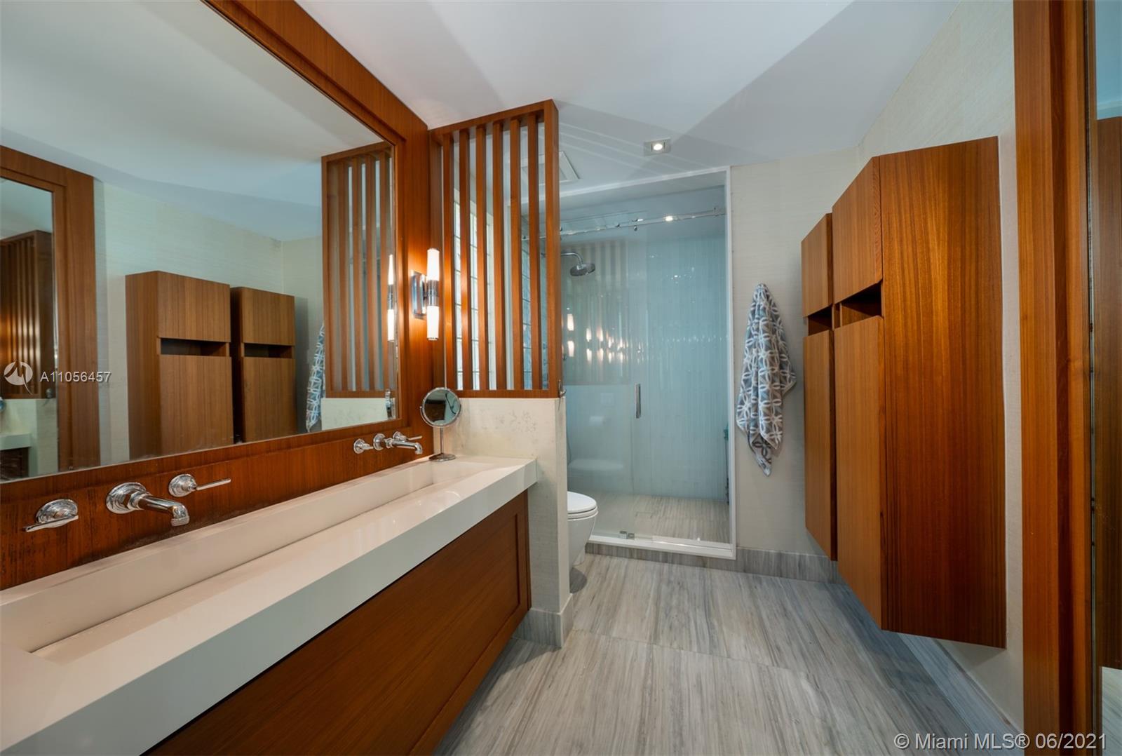 320 Pacific Road Key Biscayne, FL 33149 - Photo 14 of 27 a bathroom with a double vanity sink and mirror with shower