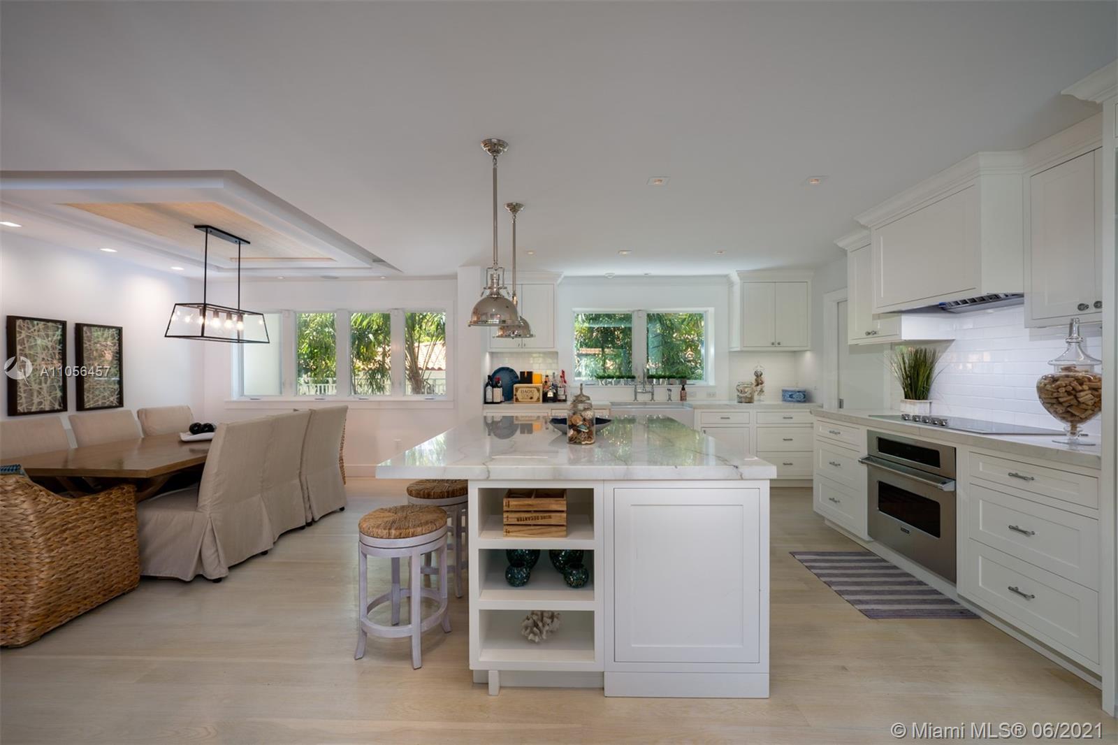 320 Pacific Road Key Biscayne, FL 33149 - Photo 17 of 27 a kitchen with stainless steel appliances kitchen island granite countertop a table and chairs
