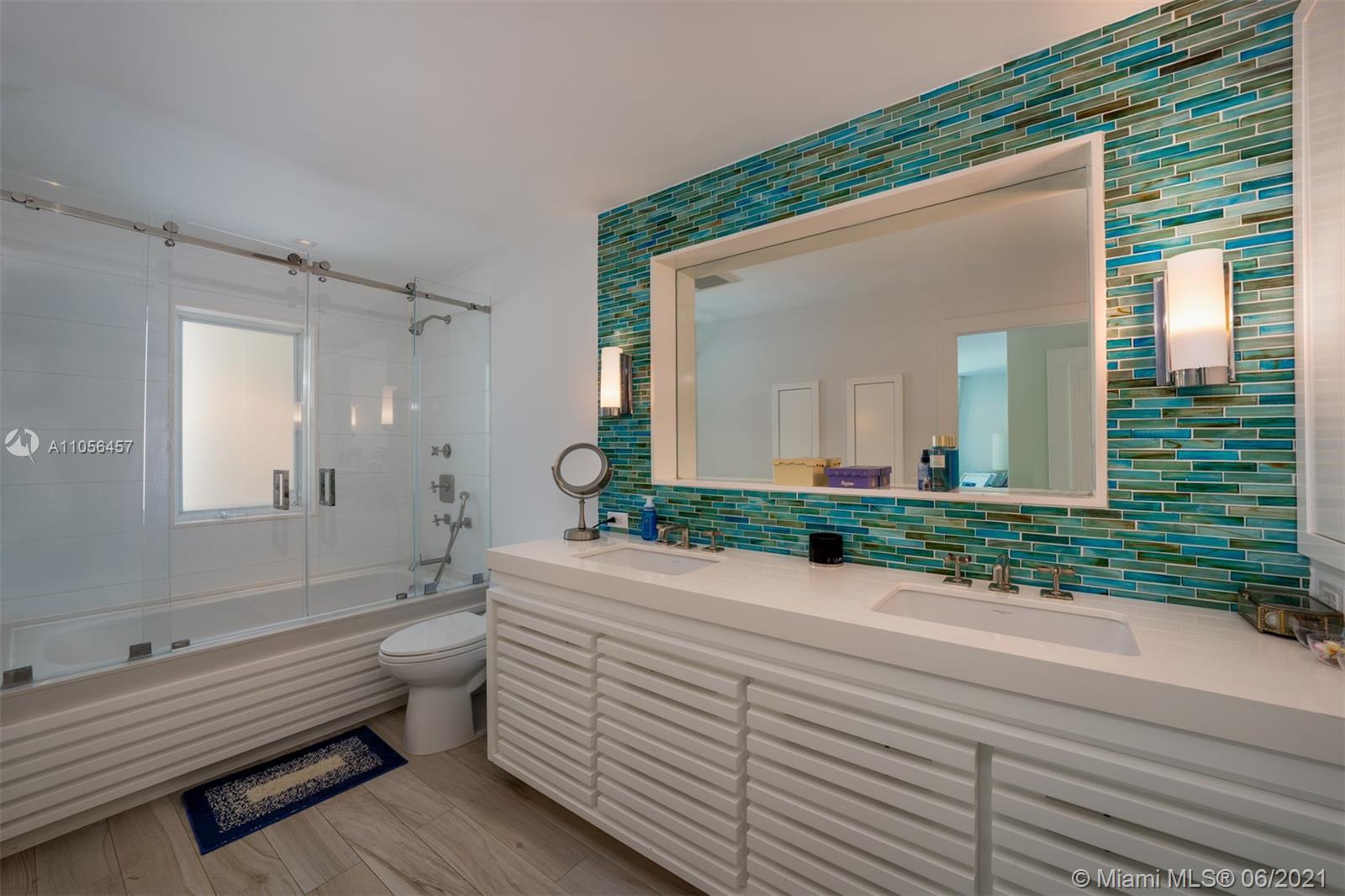 320 Pacific Road Key Biscayne, FL 33149 - Photo 21 of 27 a bathroom with a granite countertop toilet a sink and mirror