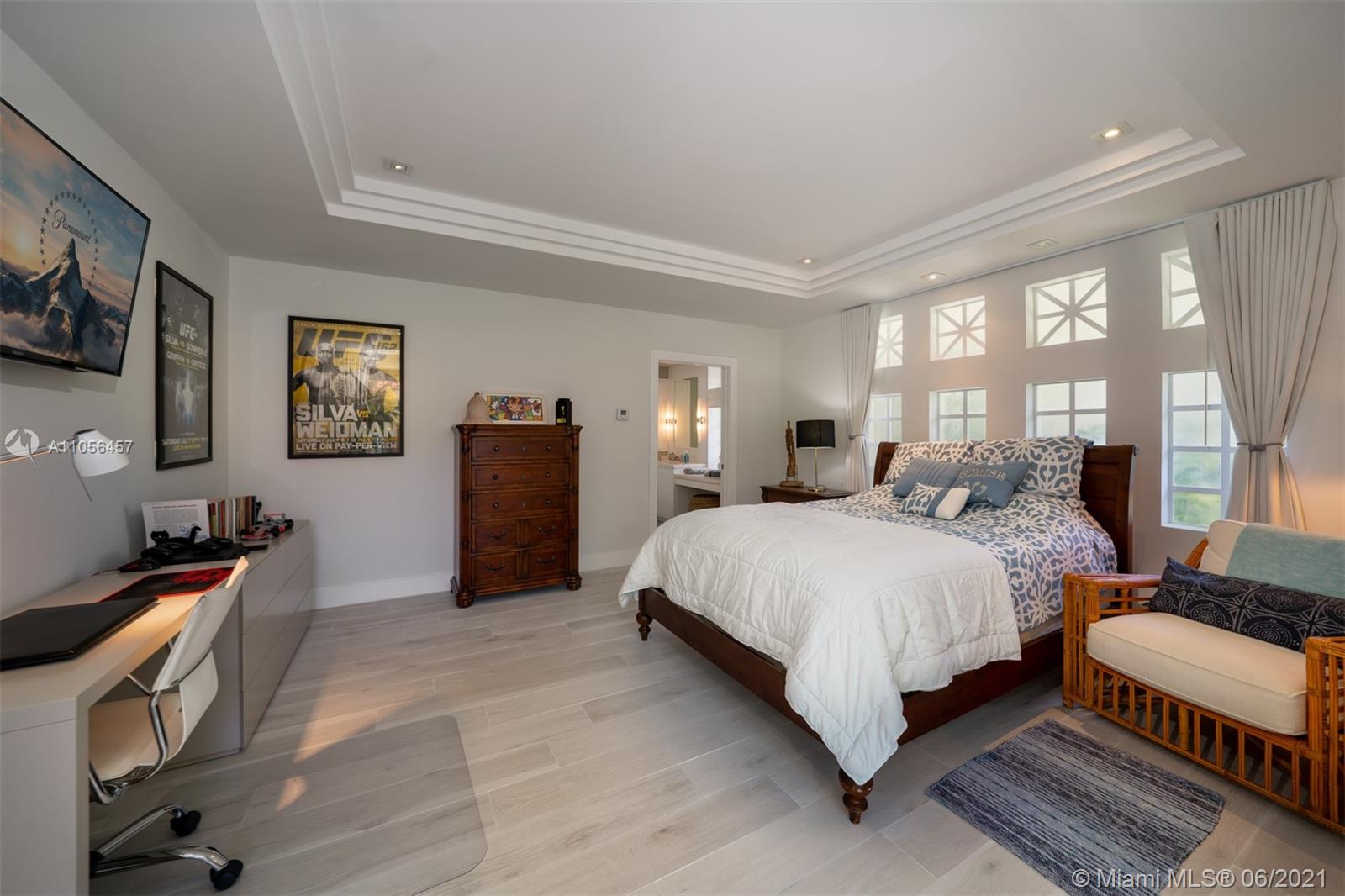 320 Pacific Road Key Biscayne, FL 33149 - Photo 22 of 27 a spacious bedroom with a bed and wooden floor