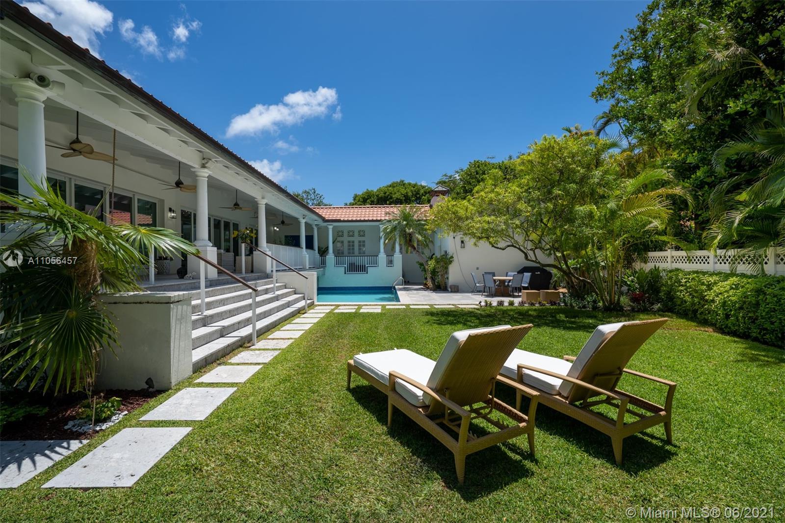 320 Pacific Road Key Biscayne, FL 33149 - Photo 4 of 27 a view of a house with backyard swimming pool and sitting area