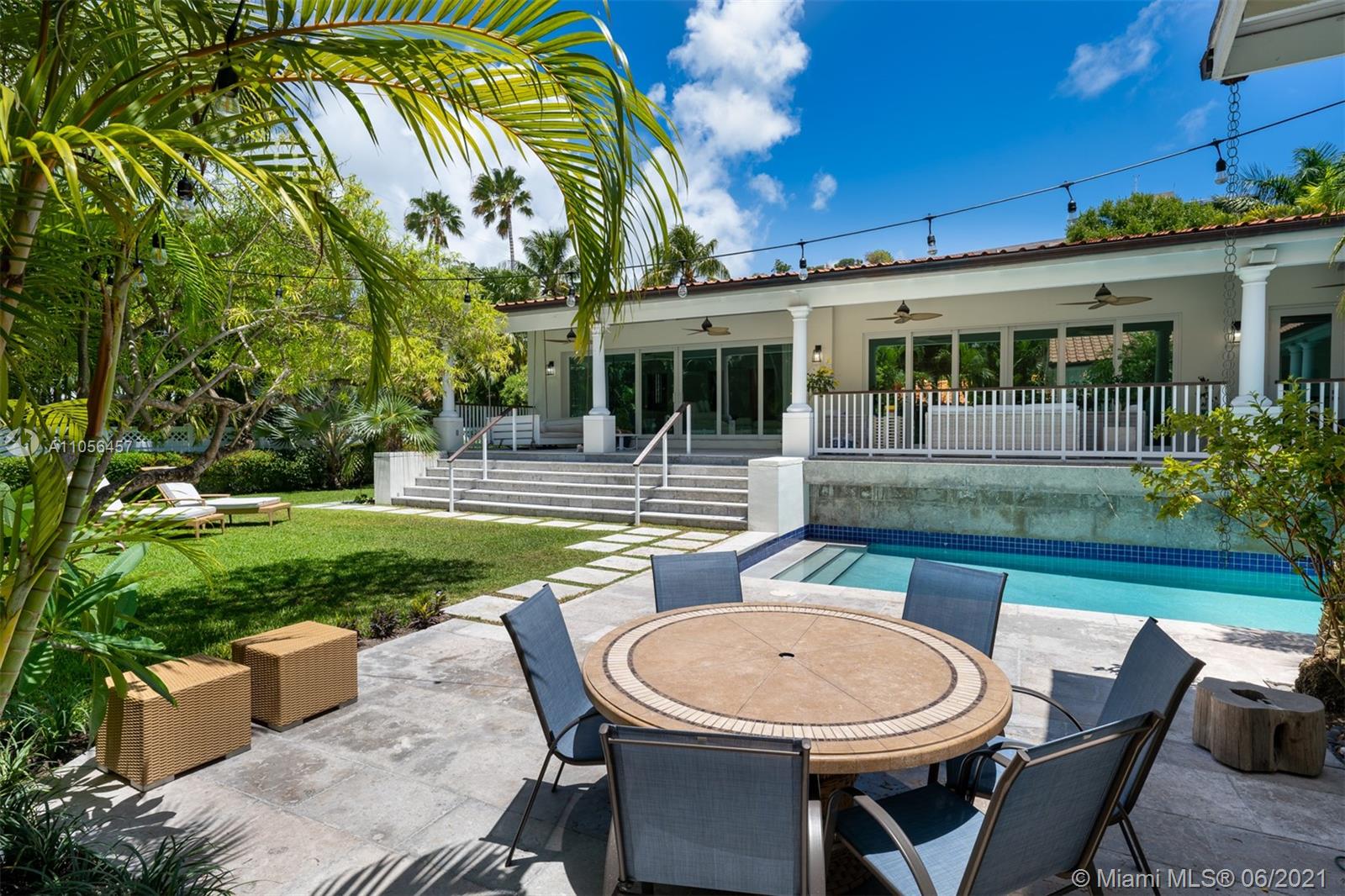 320 Pacific Road Key Biscayne, FL 33149 - Photo 6 of 27 a view of a patio with table and chairs potted plants and floor to ceiling window
