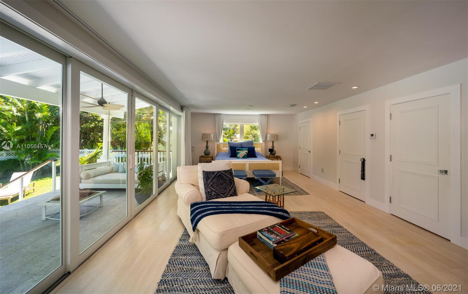 320 Pacific Road Key Biscayne, FL 33149 - Photo 8 of 27 a living room with furniture and a floor to ceiling window