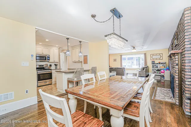 a dining room with a table chairs and kitchen view