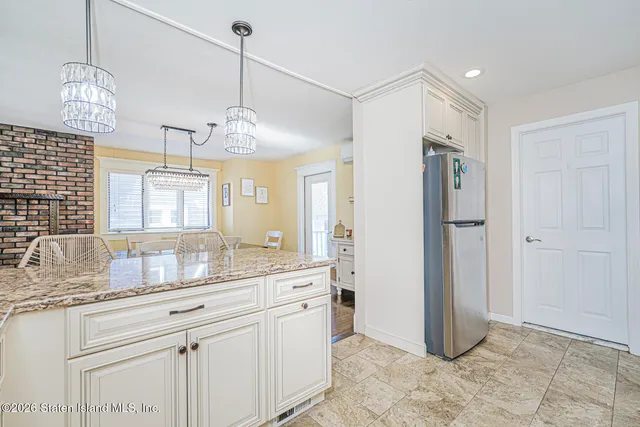 a bathroom with a granite countertop sink a mirror and shower