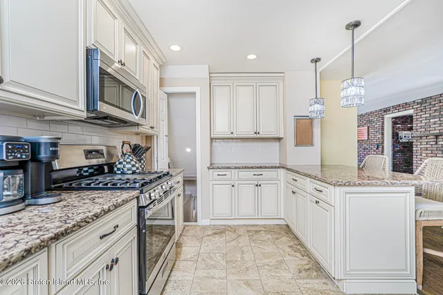 a kitchen with stainless steel appliances granite countertop a stove and a sink