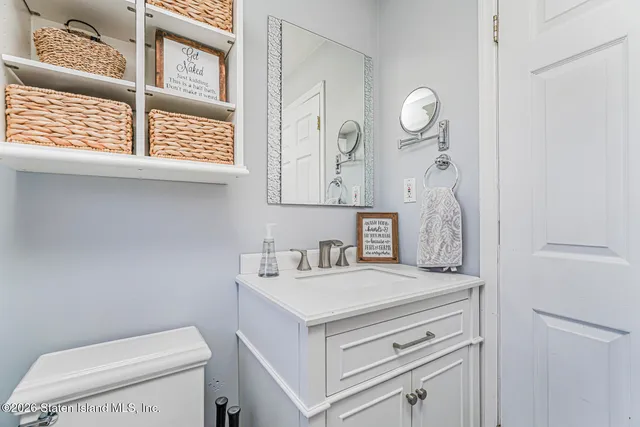 a bathroom with a sink a toilet and a window