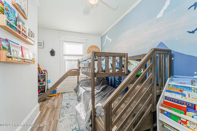 a living room with lots of baby furniture and a book shelf
