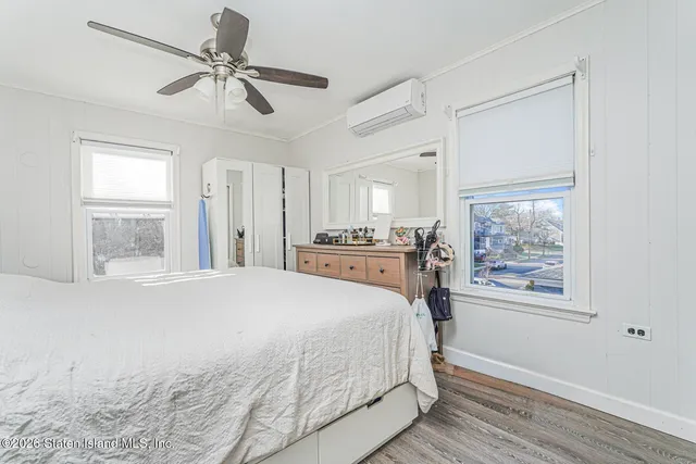 a bedroom with a large bed and a window