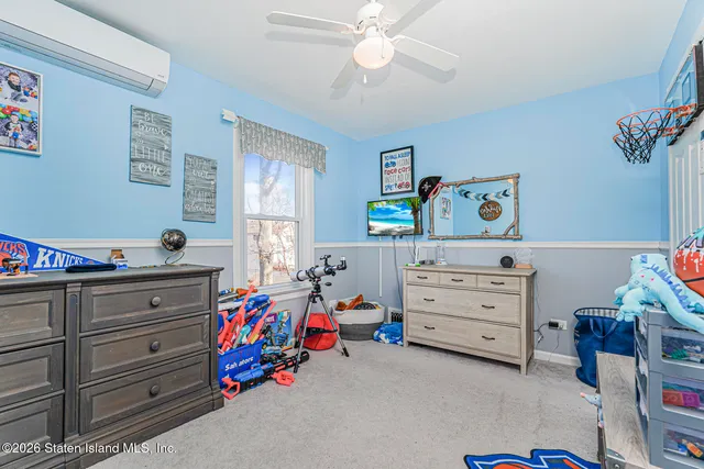 a bed room with a bed and a dresser