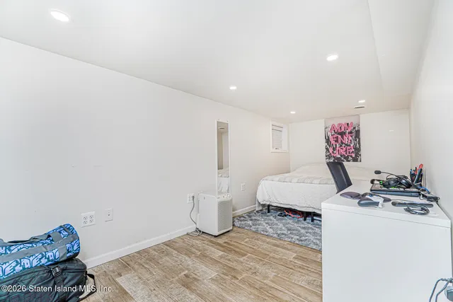 a bedroom with furniture and a wooden floor