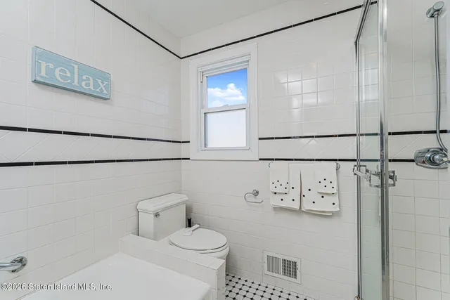 a white toilet sitting next to a bathroom sink