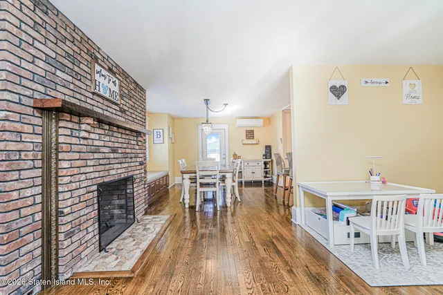 a dining room with furniture wooden floor and a rug