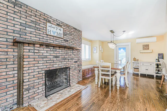 a living room with furniture a wooden floor and a fireplace