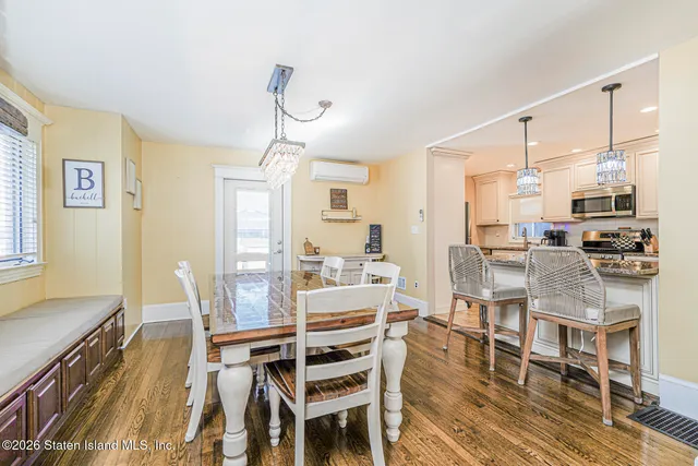 a view of a dining room with furniture window and wooden floor