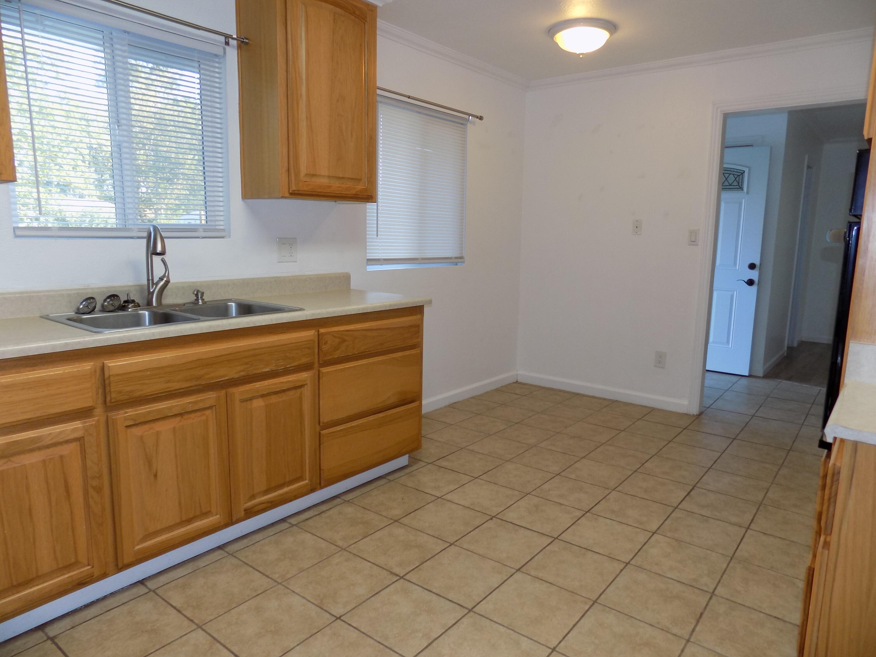 7658 Happy Valley Road Anderson, CA 96007 - Photo 11 of 25 a kitchen with sink cabinets and window