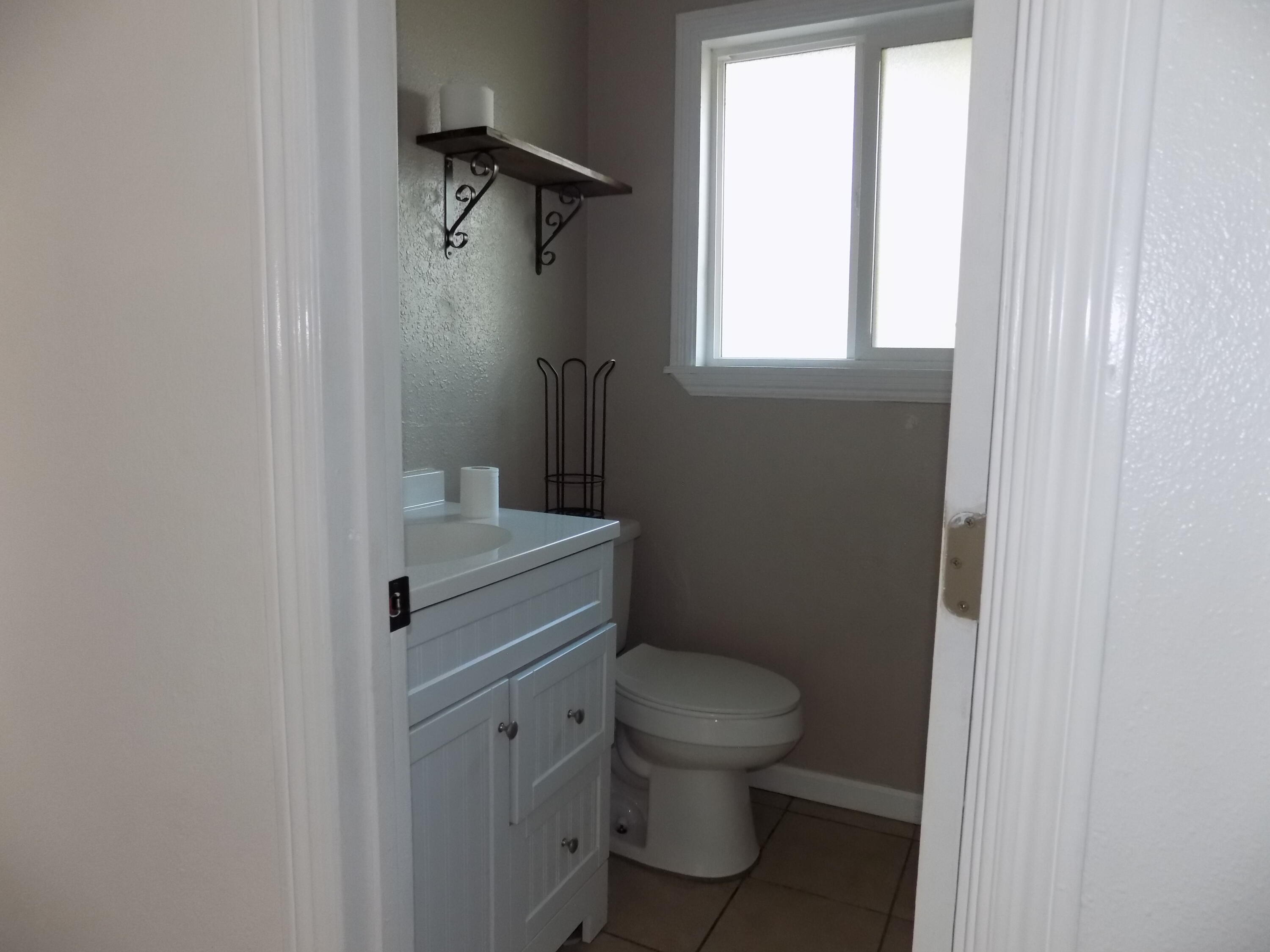 7658 Happy Valley Road Anderson, CA 96007 - Photo 13 of 25 a white toilet sitting next to a bathroom sink